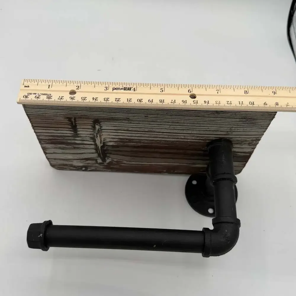 industrial-style wall-mounted toilet paper holder with a rustic wood top shelf